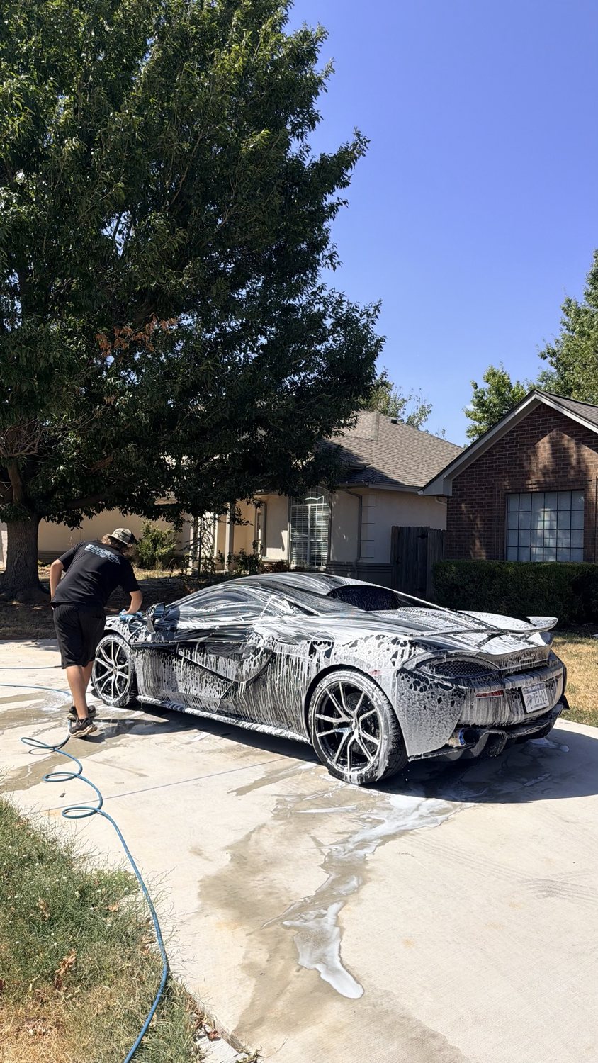 McLaren mid-wash in the driveway